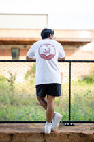 Guy wearing white streetwear shirt with red koi design