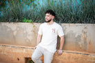 Guy wearing natural color shirt with red spider lily logo