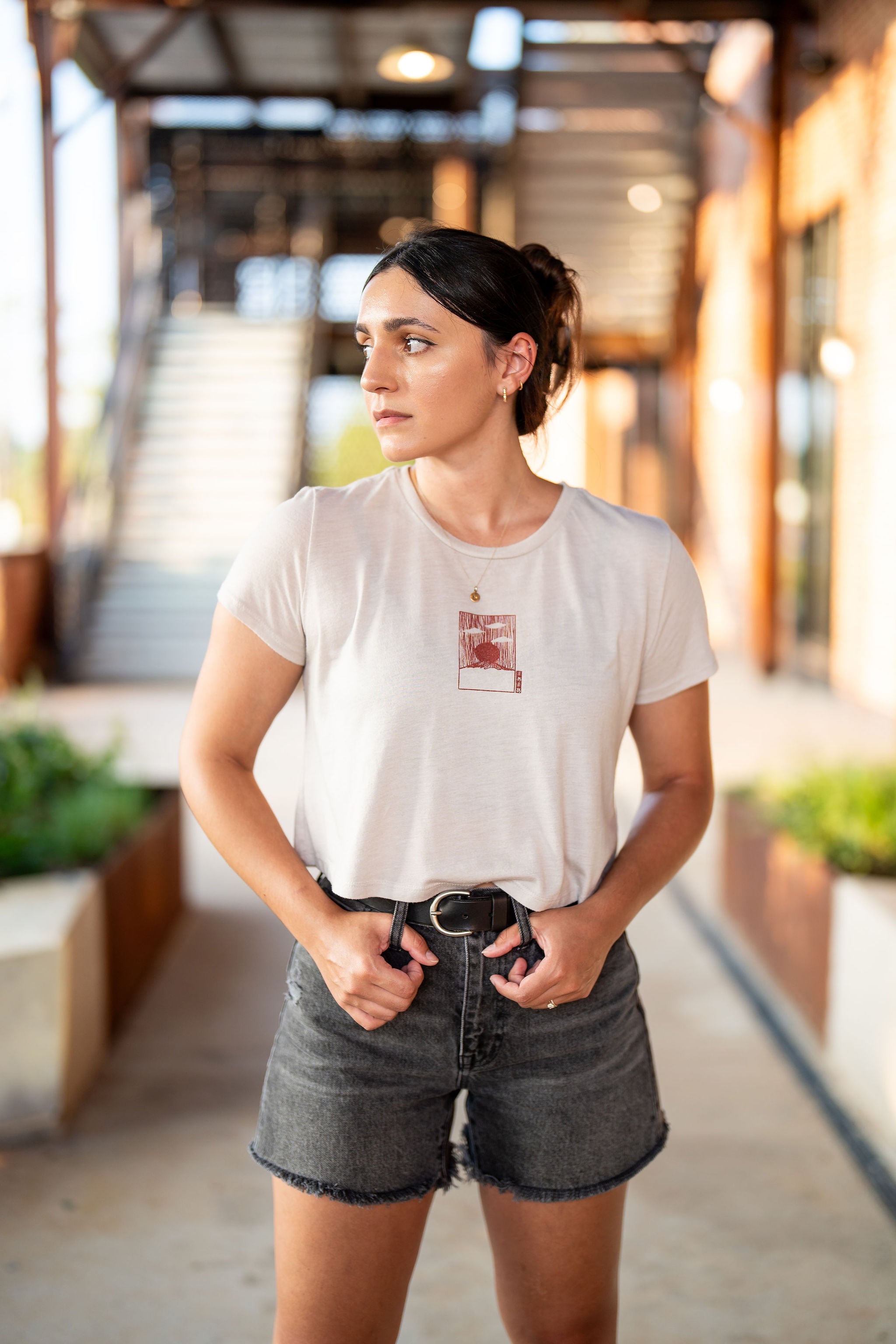 Woman wearing heather crop top with red mount fuji design