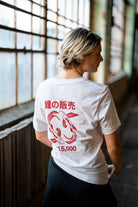 woman wearing white streetwear shirt with red koi fish design